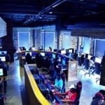 Interior view of a busy esports gaming center, illustrating the result of implementing the basics of opening an esports center.