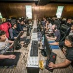 Esports teams practicing together, showing the benefits of a gaming center for esports teams.